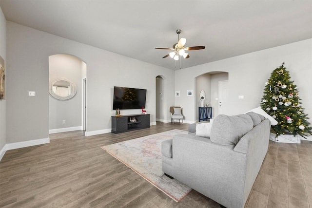 living room featuring hardwood / wood-style floors and ceiling fan