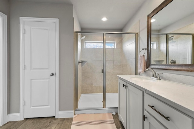 bathroom with vanity, hardwood / wood-style floors, and walk in shower