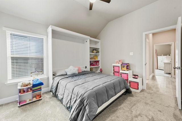 bedroom featuring light carpet, vaulted ceiling, and ceiling fan