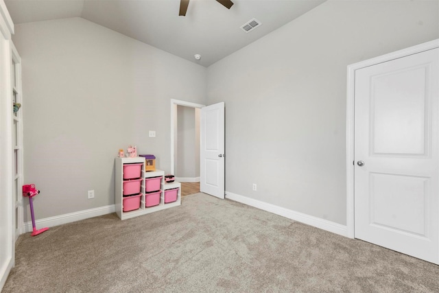 game room with vaulted ceiling, light carpet, and ceiling fan