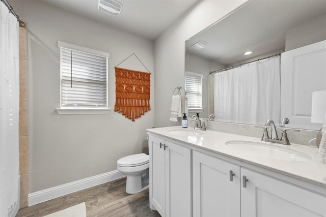 bathroom featuring hardwood / wood-style floors, vanity, and toilet