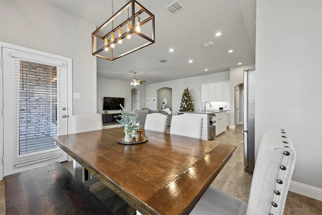 dining room with sink, ceiling fan, and light hardwood / wood-style flooring