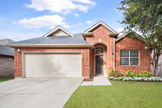 view of front of home featuring a garage and a front lawn