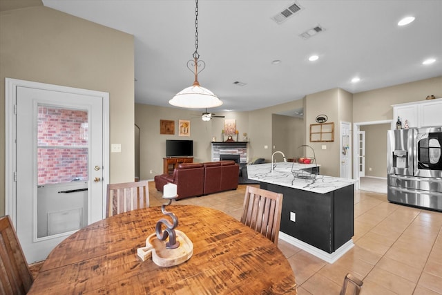 tiled dining space featuring ceiling fan