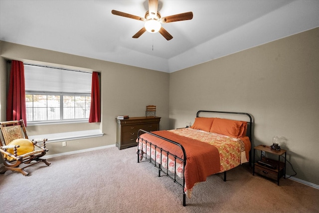 bedroom featuring lofted ceiling, light colored carpet, and ceiling fan