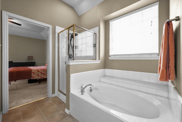 bathroom featuring tile patterned flooring and shower with separate bathtub