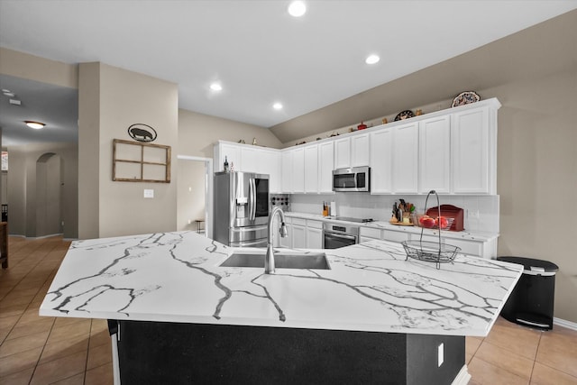 kitchen with white cabinetry, appliances with stainless steel finishes, a large island, and sink