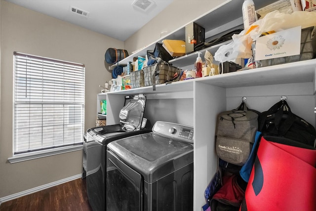 laundry area with dark wood-type flooring and washer and clothes dryer