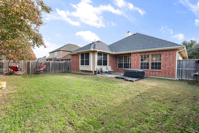 rear view of property featuring a yard and a patio