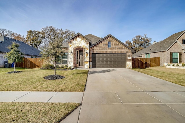 view of front of house with a front yard and a garage