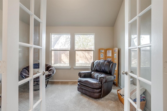 living area featuring carpet flooring, vaulted ceiling, and french doors