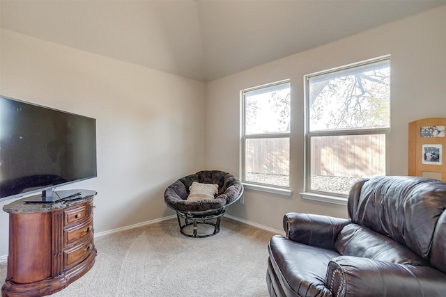 sitting room featuring light colored carpet and lofted ceiling