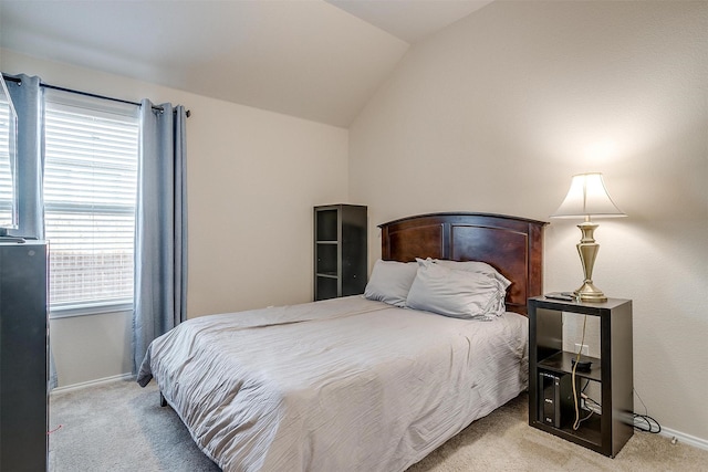 carpeted bedroom with lofted ceiling