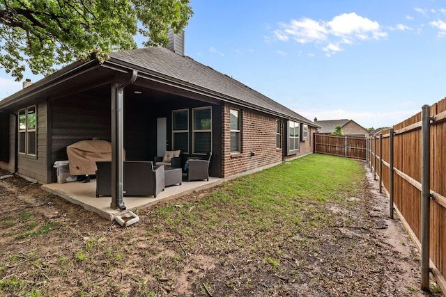 221 Gardenia Dr, Azle, TX 76020 - back of property with a patio area, outdoor lounge area, a chimney, brick siding, and a shingled roof