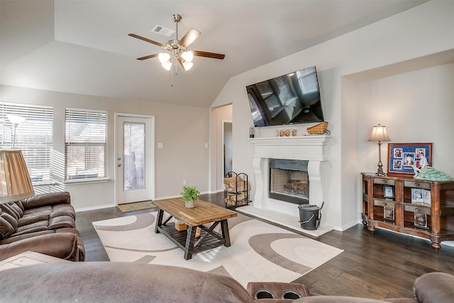 living room featuring dark hardwood / wood-style flooring, ceiling fan, and lofted ceiling