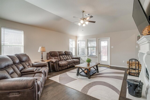 living room featuring ceiling fan, lofted ceiling, dark wood-type flooring, and a wealth of natural light