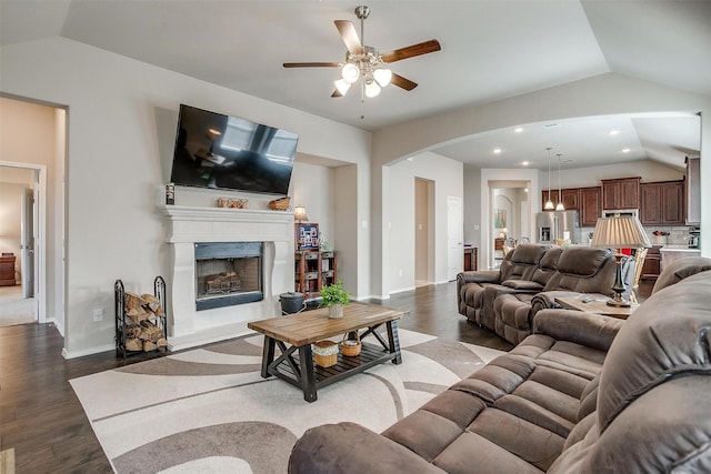 living room with ceiling fan, dark hardwood / wood-style flooring, and lofted ceiling