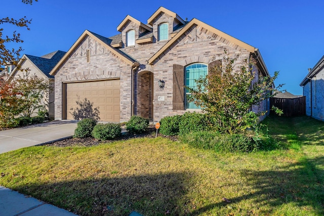 view of front of property featuring a garage and a front yard