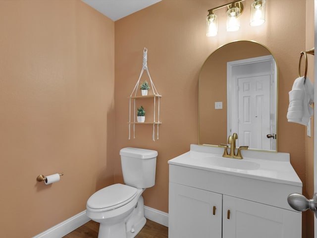 bathroom featuring hardwood / wood-style flooring, vanity, and toilet