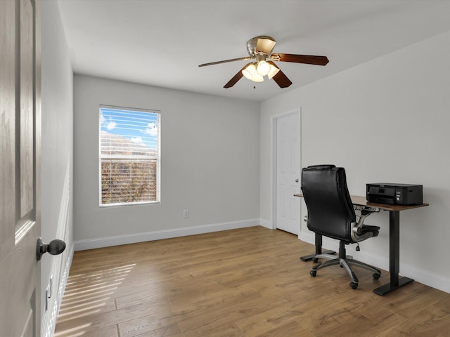 home office featuring light wood-type flooring and ceiling fan