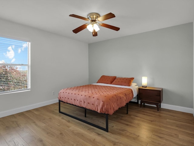 bedroom with hardwood / wood-style floors and ceiling fan