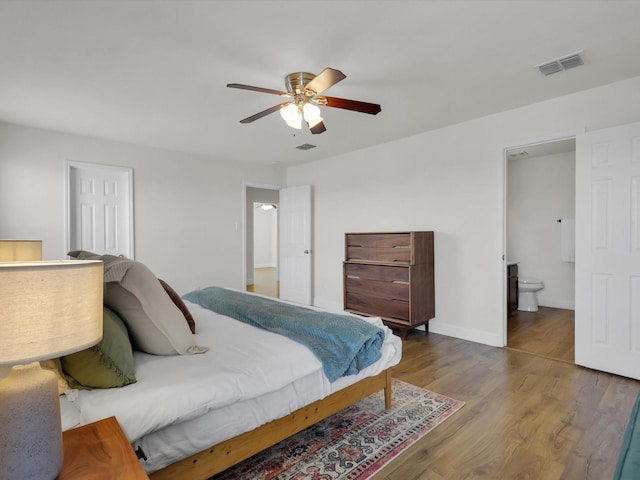 bedroom featuring wood-type flooring, ensuite bathroom, and ceiling fan