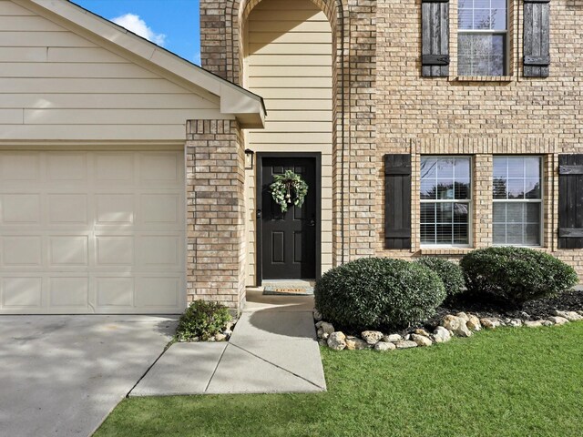 view of exterior entry featuring a garage