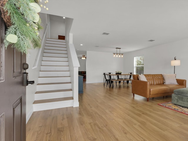 living room featuring ceiling fan and light wood-type flooring