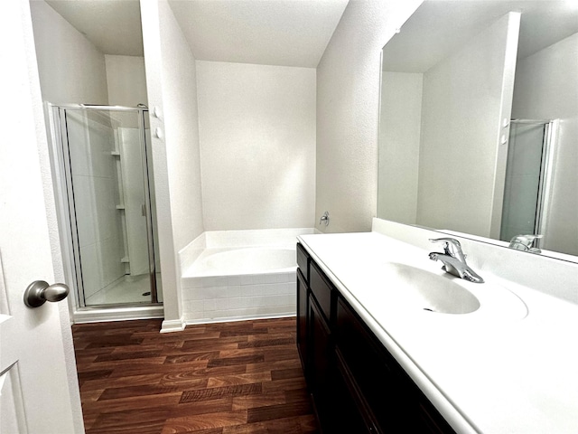 bathroom featuring separate shower and tub, vanity, and hardwood / wood-style flooring