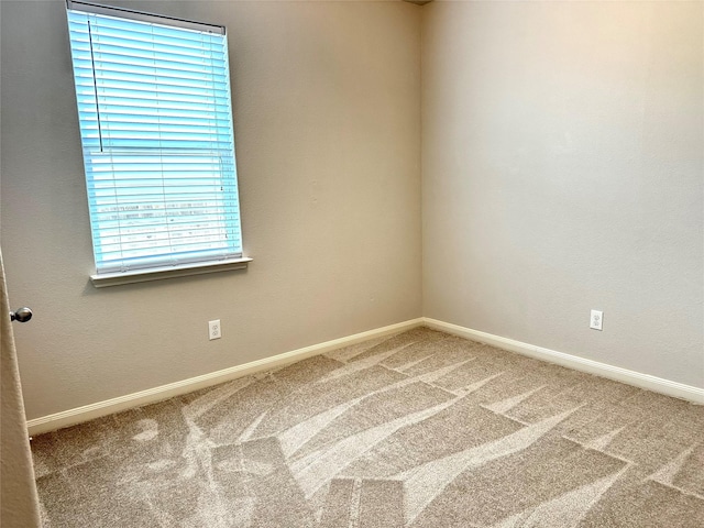 empty room featuring a wealth of natural light and carpet floors