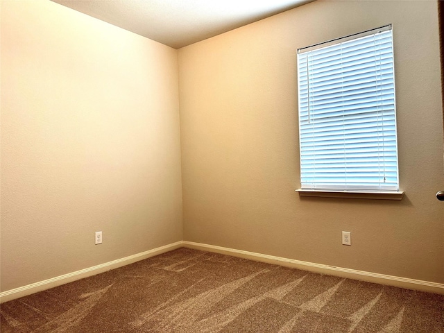 carpeted spare room with a healthy amount of sunlight