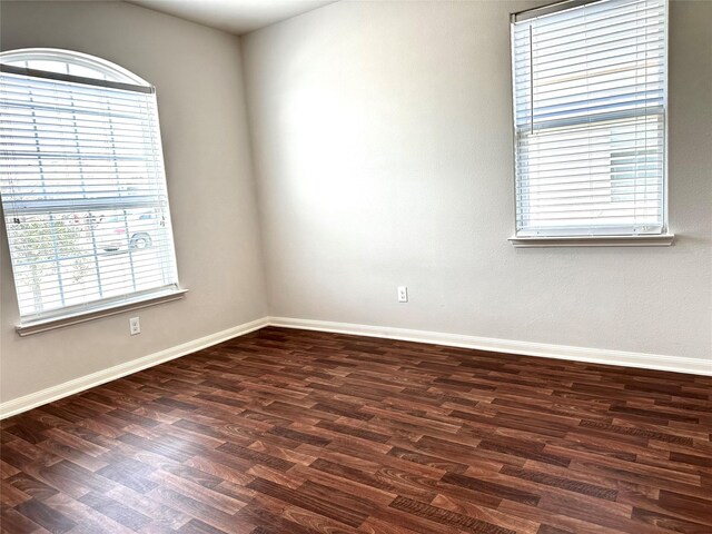 unfurnished room featuring dark hardwood / wood-style flooring