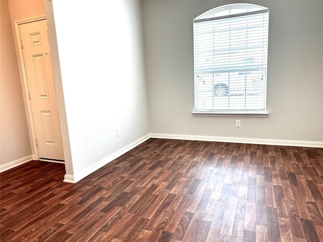 empty room featuring dark hardwood / wood-style flooring and a healthy amount of sunlight