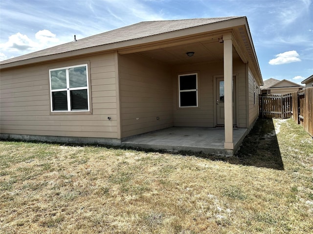 back of house with a yard and a patio area