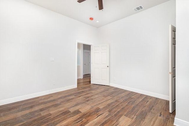 unfurnished room with ceiling fan and dark hardwood / wood-style flooring