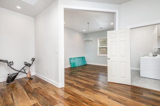 interior space featuring a chandelier and dark wood-type flooring