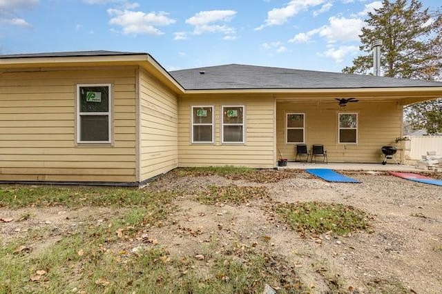 back of house with ceiling fan and a patio area