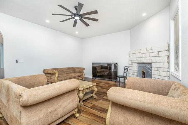 living room featuring hardwood / wood-style floors and ceiling fan