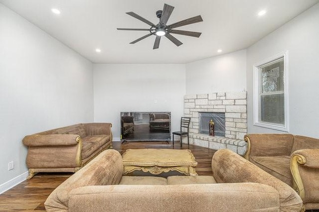 living room featuring ceiling fan and hardwood / wood-style floors