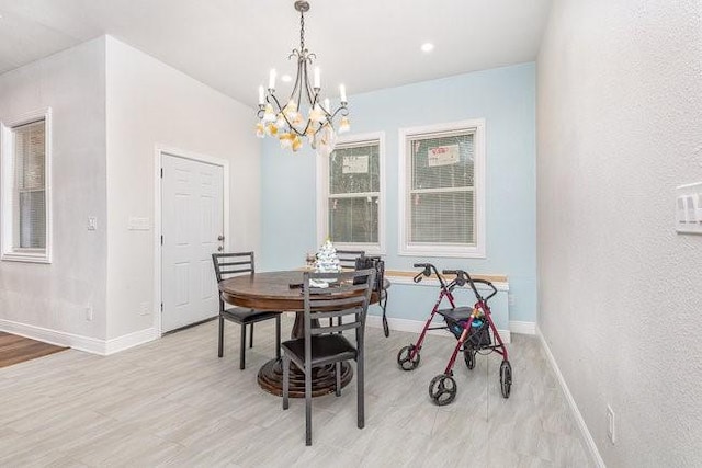 dining area with a notable chandelier and light wood-type flooring