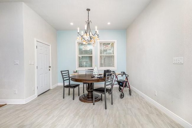 dining room with an inviting chandelier and light hardwood / wood-style flooring