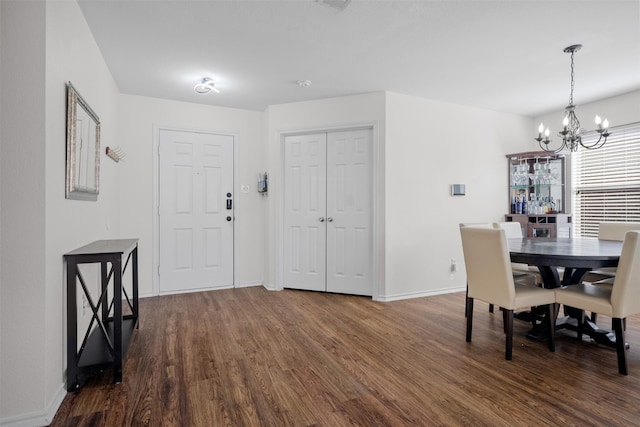 dining room featuring dark hardwood / wood-style floors and a chandelier