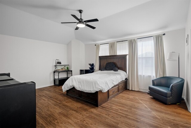 bedroom featuring hardwood / wood-style flooring, ceiling fan, and vaulted ceiling