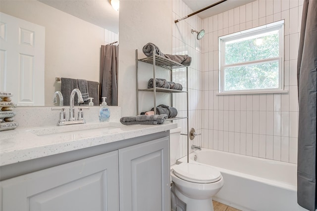 full bathroom featuring shower / bath combination with curtain, vanity, and toilet