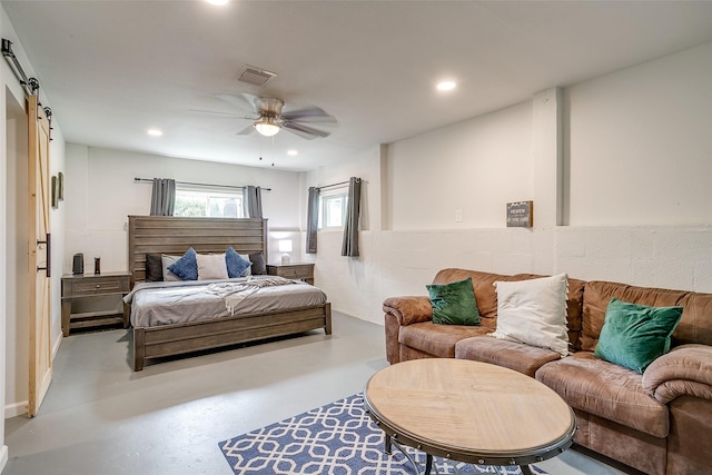 bedroom featuring a barn door and ceiling fan