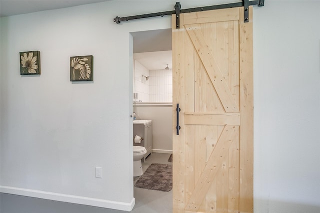 bathroom featuring toilet and concrete floors