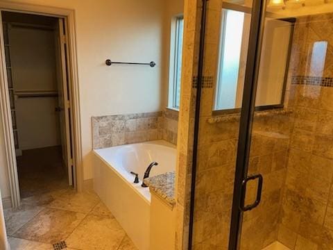 bathroom with a healthy amount of sunlight and plus walk in shower