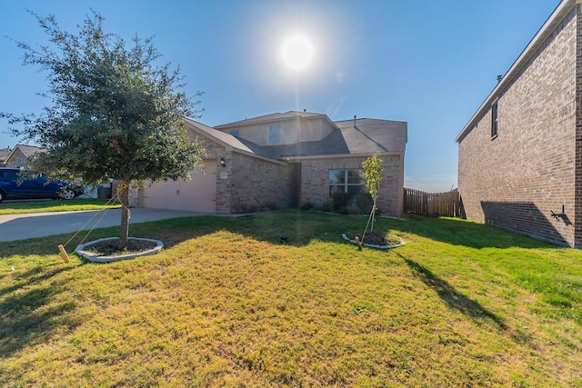 view of front of property featuring a front yard and a garage