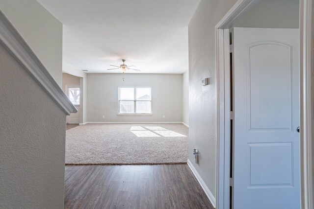 unfurnished room featuring ceiling fan and dark wood-type flooring