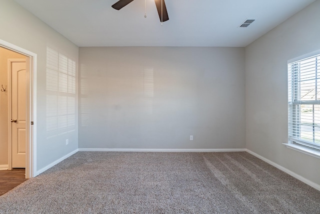 carpeted spare room featuring ceiling fan